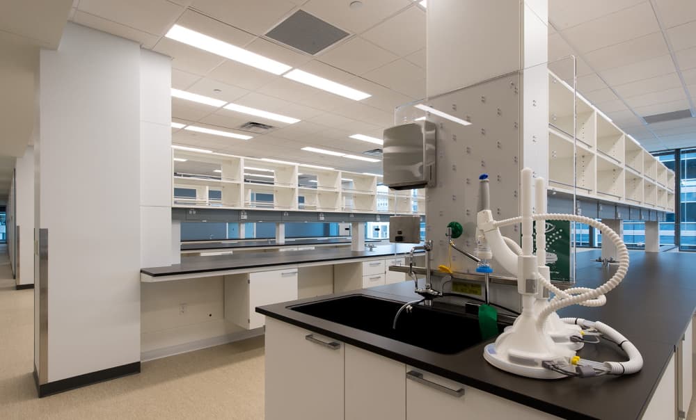 Biopharmaceutical research laboratory with bench casework, fume hoods, and eyewash stations, wired by H&M Electric