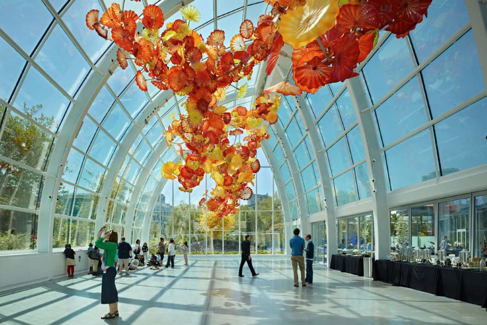 Glasshouse interior with a suspended glass sculpture and feature lighting